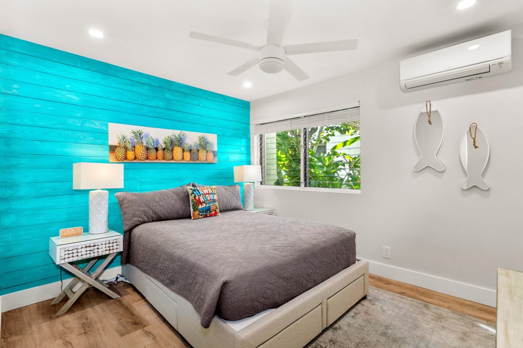 Bedroom with queen bed, split AC and ceiling fan