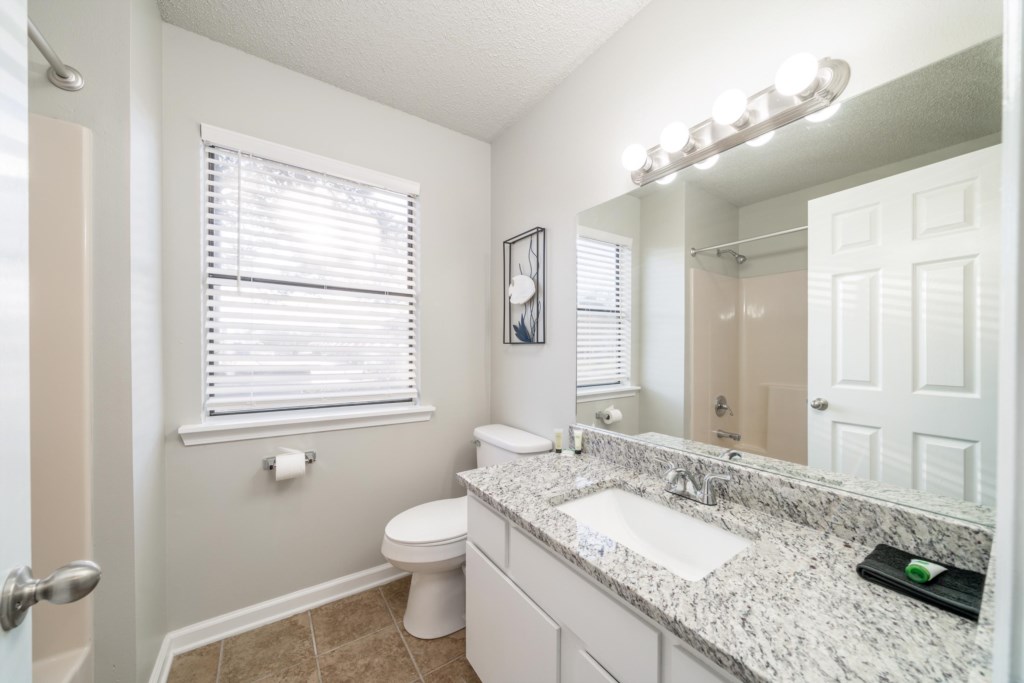 Upstairs bathroom in hallway with shower tub combo