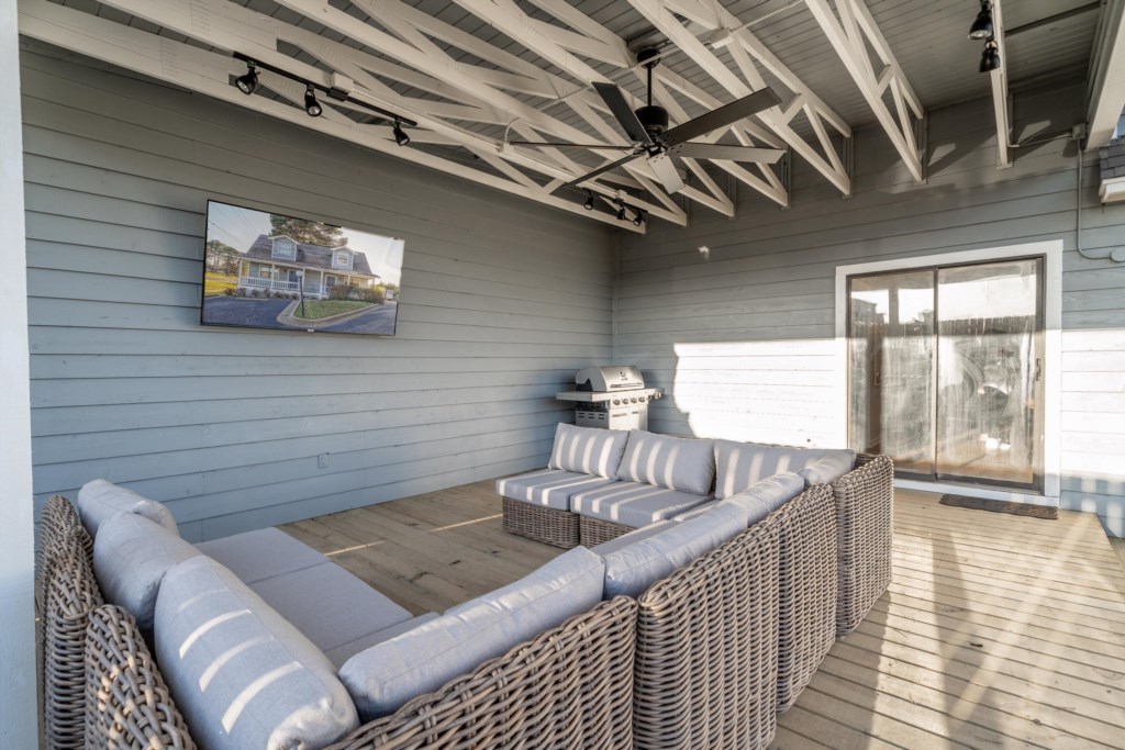 covered patio with 65 in tv and gas grill
