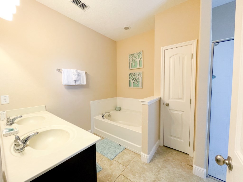 Bathroom 1 - En suite bathroom with tub, walk in shower, double sinks, toilet corner, private access to pool 
