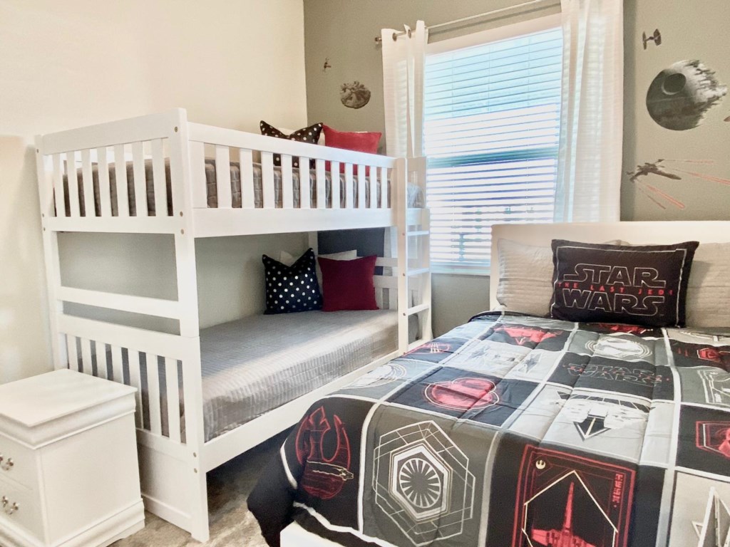 Star Wars themed kids room with 1 double bed and 1 twin bunk bed. Sleeps 4.