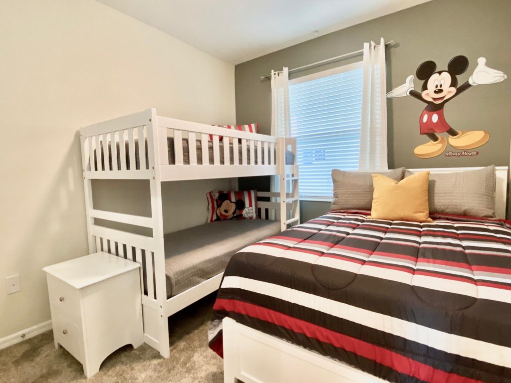 Tasteful Mickey Mouse themed kids room with 1 double bed, and a twin bunk bed. Sleeps 4.