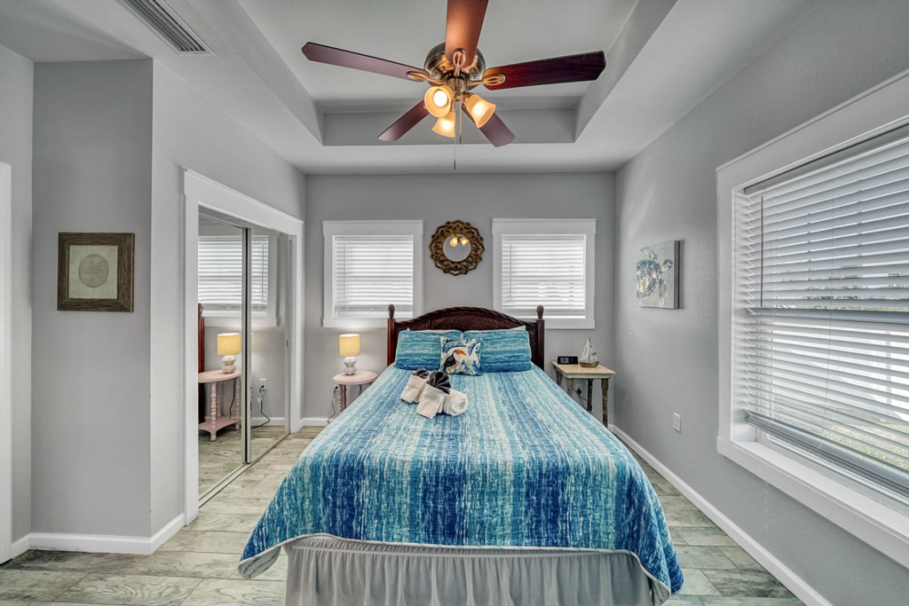 Queen Master Bedroom with flat screen television, ceiling fan, and attached bath
