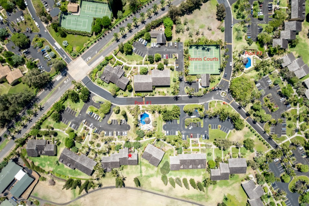 Aerial View Showing Proximity to Community Pools and Tennis Courts - Unit Depicted with a Red Star
