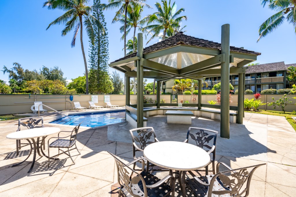 Community Pool with a Gazebo and Tables for Relaxing 