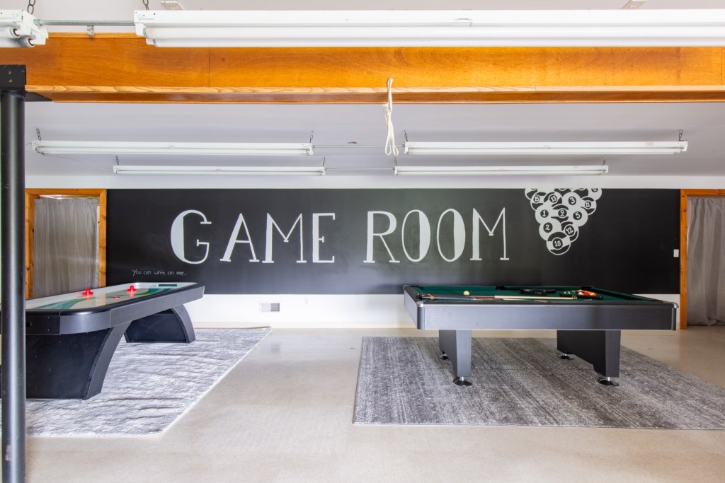 Large game room in the basement with a leveled pool table, foosball, AND air hockey! 