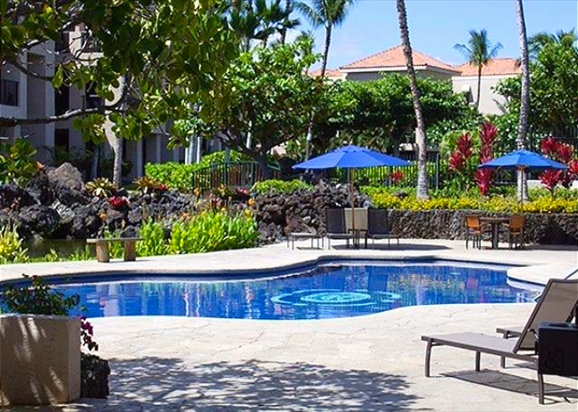 Relax by the tranquil resort-style pool, surrounded by lush tropical landscaping and comfortable sun loungers.