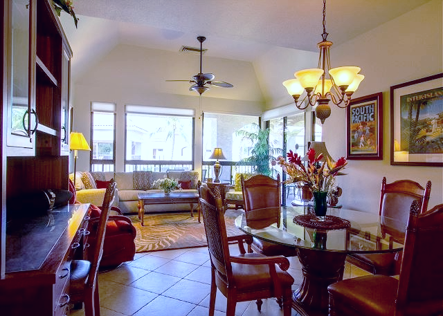 Spacious open plan living area with tropical decor, ideal for relaxing or entertaining guests.