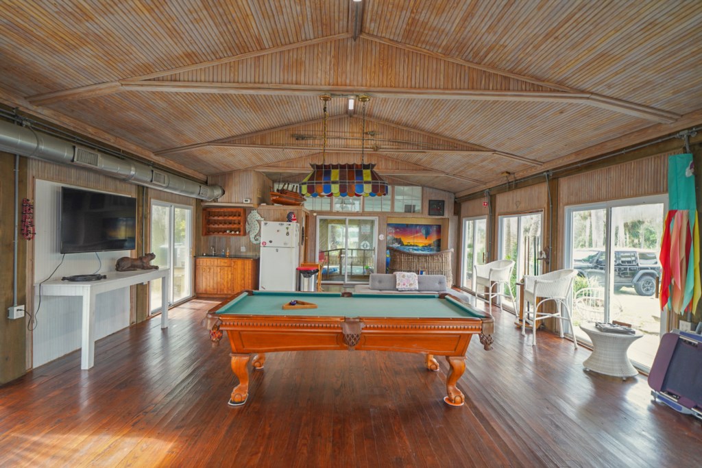 Pool table with large flat screen television make a great entertaining area to watch sports
