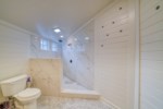 The Main House at The Grove; marble walls featuring double rainfall shower heads 