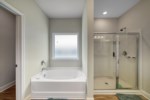 Master Bathroom with soaking tub, walk-in shower, and private water closet 