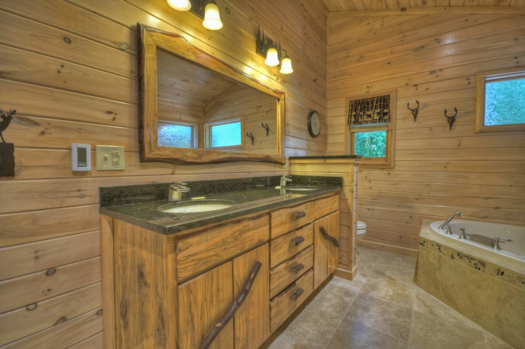 Master bathroom on the main level with a stand alone jetted tub and walk in shower 