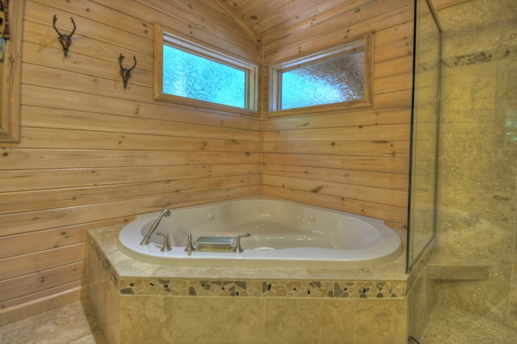 Master bathroom on the main level with a stand alone jetted tub and walk in shower 