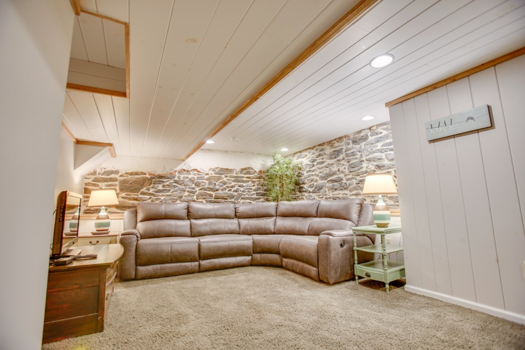 The basement offers a great place to hangout with 2 couches, a double bed, and a TV.
