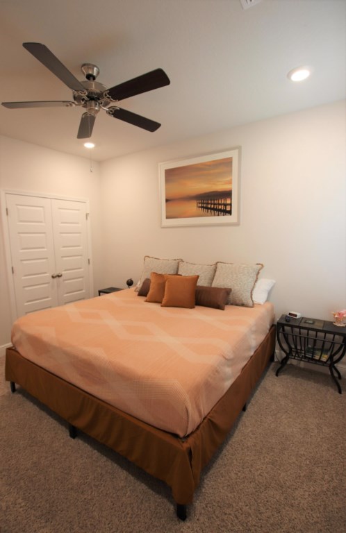 Additional king bedroom with television and ceiling fan; located in the attached suite