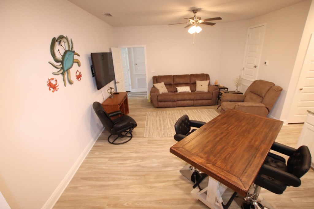 Additional living room with fully stocked kitchen, additional dining space, and comfortable seating 