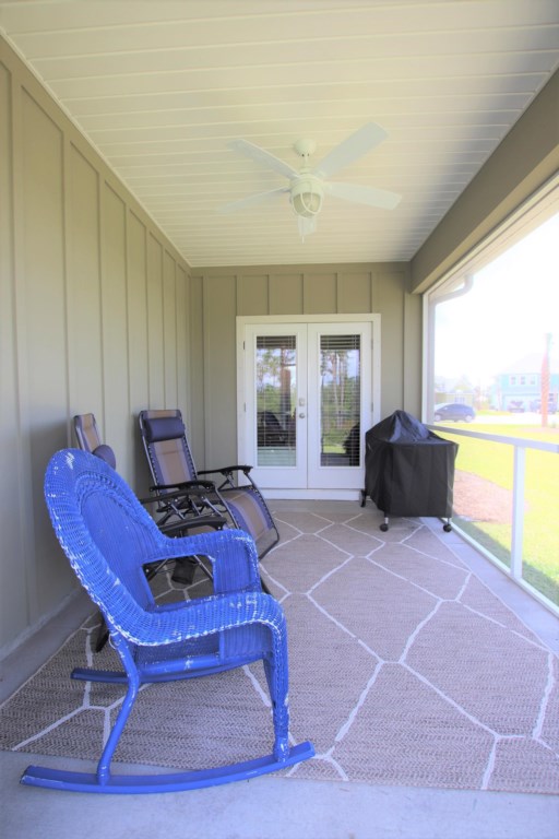 Located off the main kitchen is the screened porch with Green Egg grill, rocking chairs, and lush open lawn 