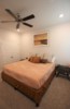 Additional king bedroom with television and ceiling fan; located in the attached suite