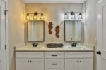 attached bathroom with double vanity and large closet 