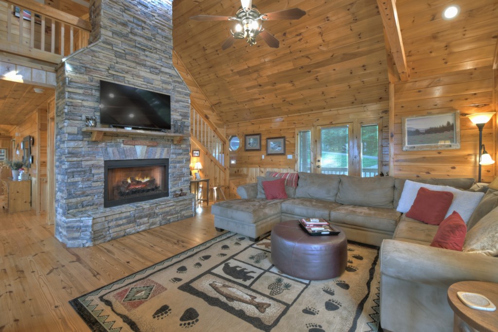 Main level living area with tv and seasonal gas fireplace 