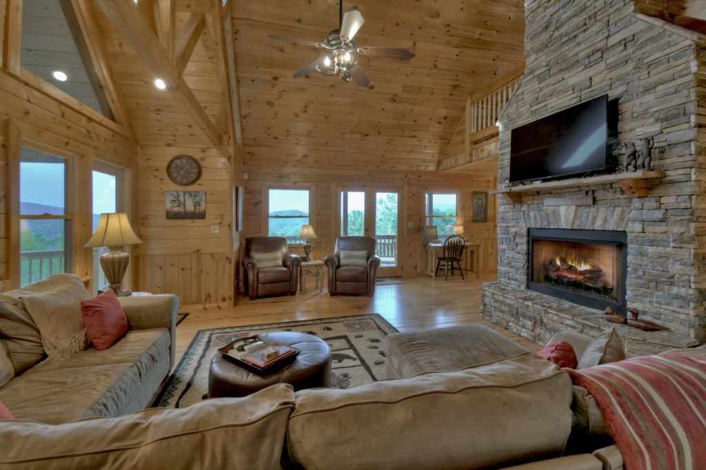 Main level living area with tv and seasonal gas fireplace 