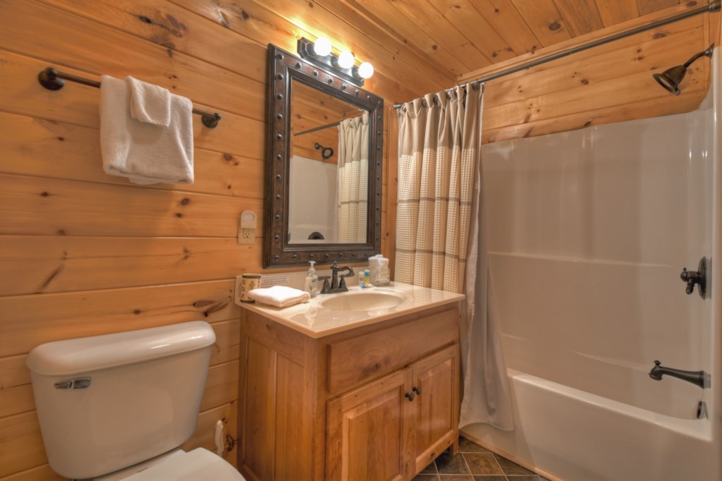 bathroom on the main level attached to queen bedroom with tub/shower combo 