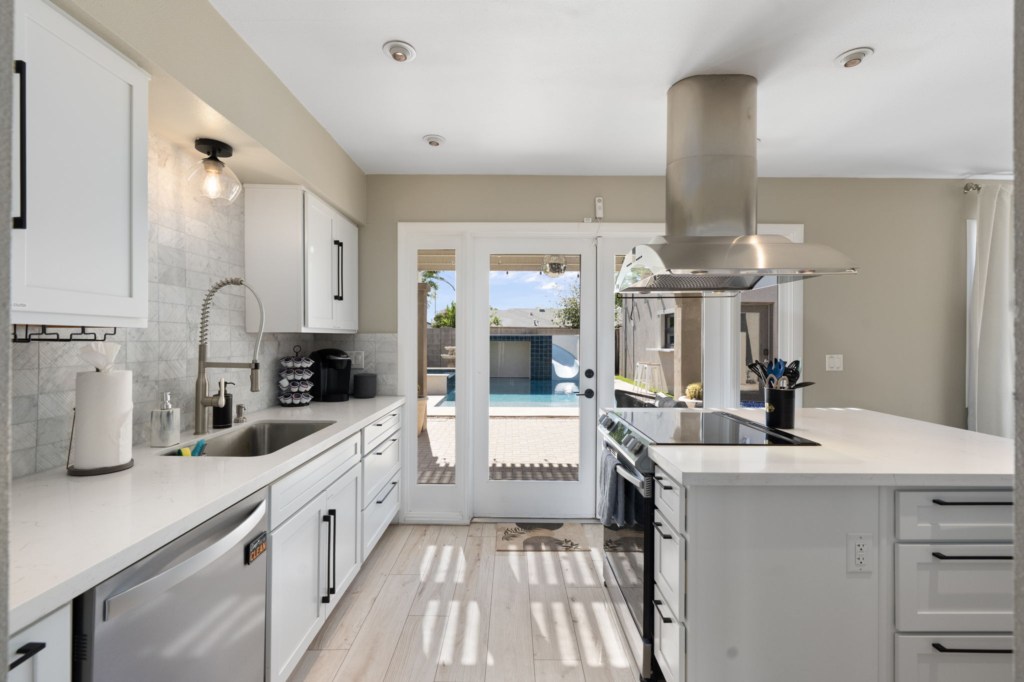 Modern kitchen with pool view, perfect for cooking and entertaining.