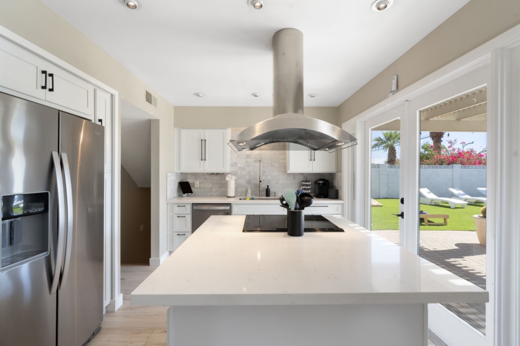 Modern kitchen with island and patio access, perfect for indoor-outdoor entertaining.