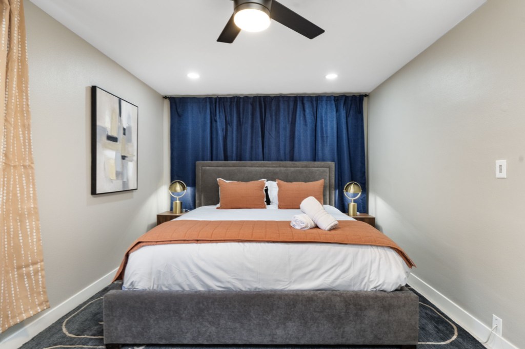 Cozy bedroom with modern decor and plush bedding for a restful night's sleep.