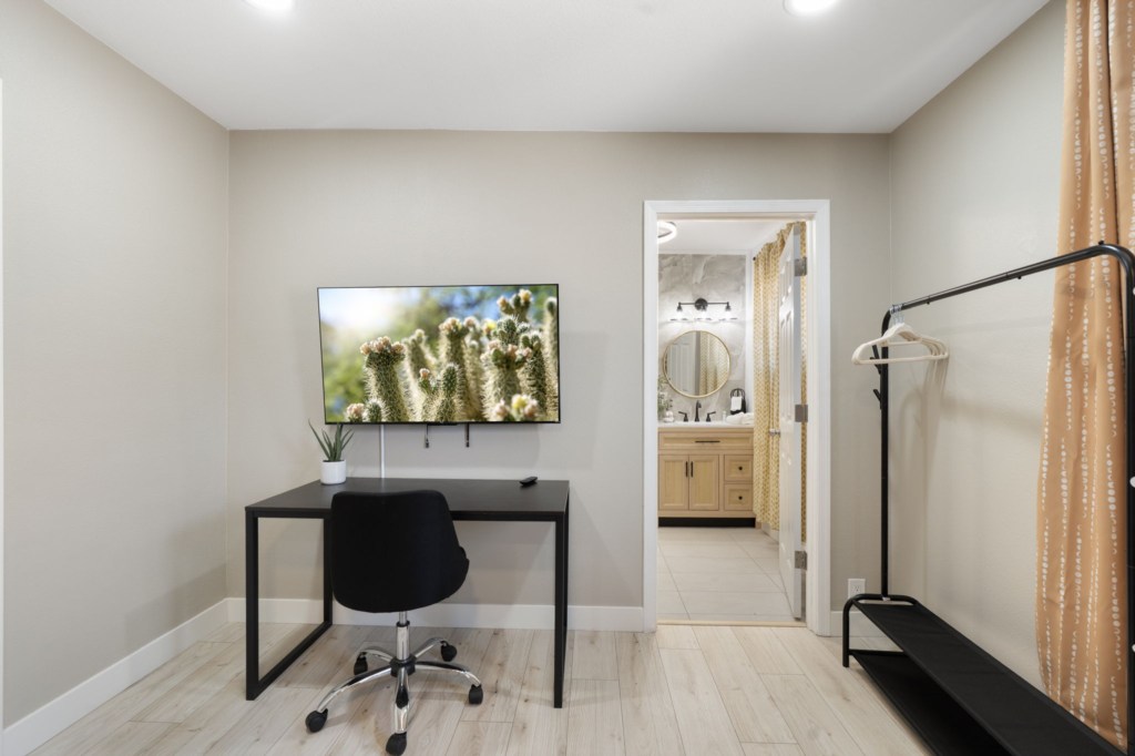 Cozy workspace with desk, chair, and bathroom access for convenience.