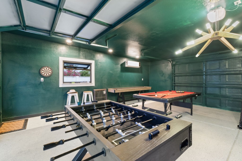 Fun games room with foosball, pool table, and dartboard for endless entertainment.