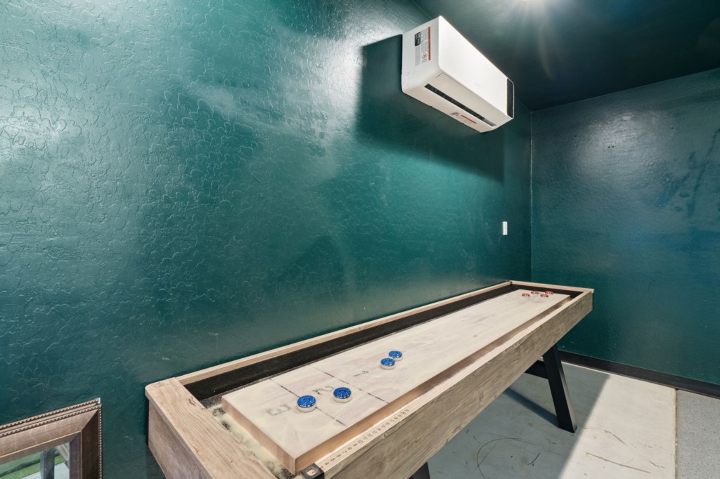 Cozy game room featuring a shuffleboard table for endless fun.