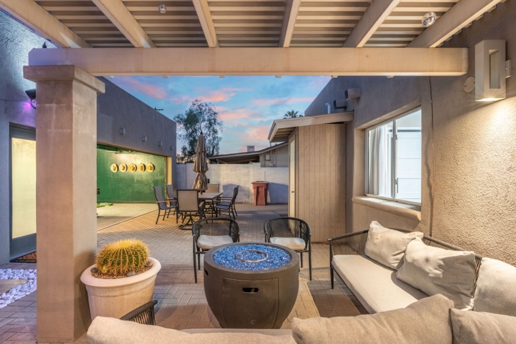 Charming patio with cozy seating and fire pit, perfect for evening relaxation.