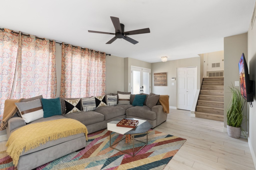 Spacious living room with comfy sectional and vibrant decor, perfect for relaxing or entertaining.