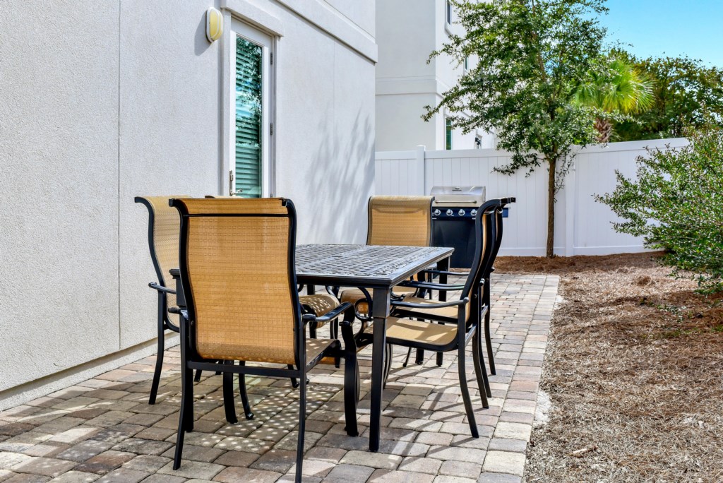 Outdoor dining table with a propane grill