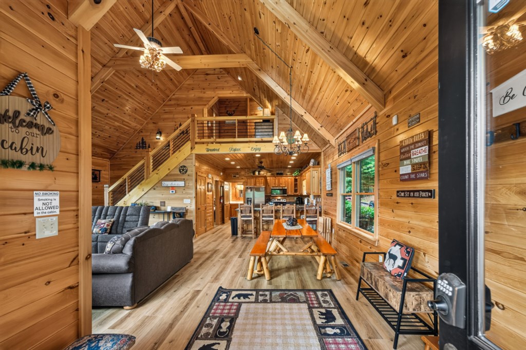 Rustic open-plan cabin with cozy seating and a welcoming dining area for family gatherings.