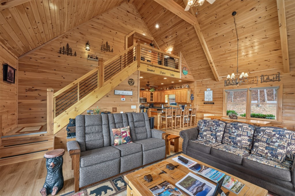 Cozy cabin living area with rustic decor and open kitchen, perfect for family gatherings.