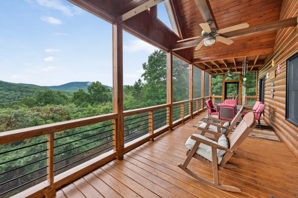 Relax on the spacious deck with stunning mountain views and cozy seating.