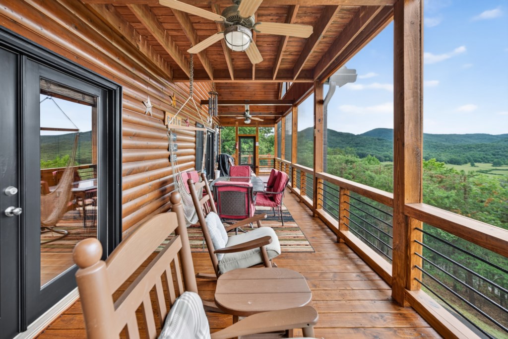 Relax on the spacious deck with stunning mountain views and cozy seating.