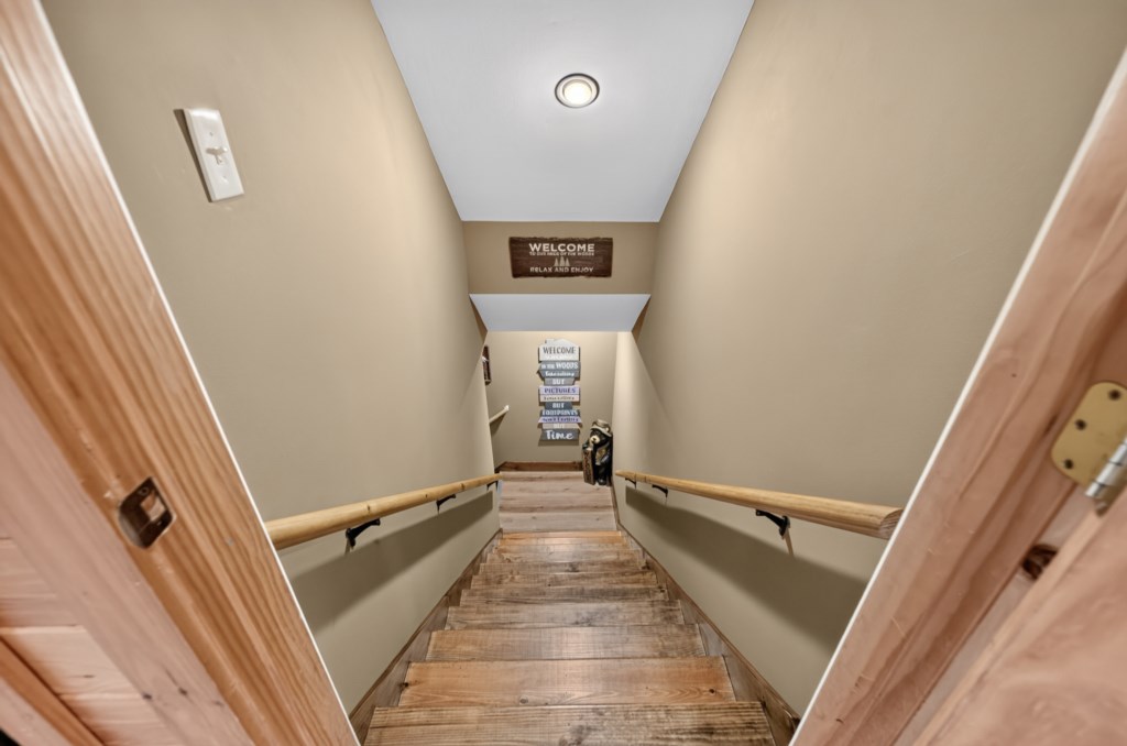 Inviting staircase with warm wood accents leading to cozy living spaces.