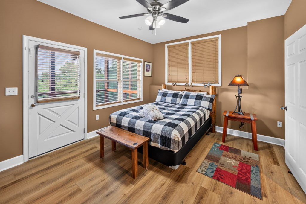 Cozy bedroom with rustic charm and private deck access.