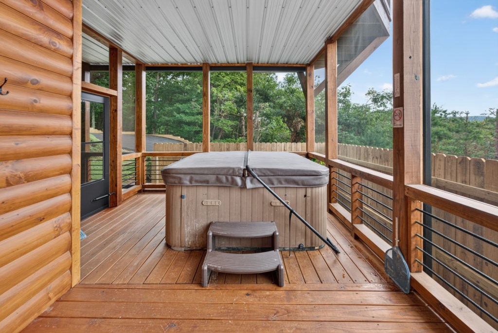 Relax in the private screened porch with a hot tub and serene forest views.