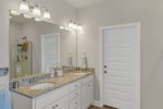 Double vanities, large walk-in closet, and private water closet compose the primary bath