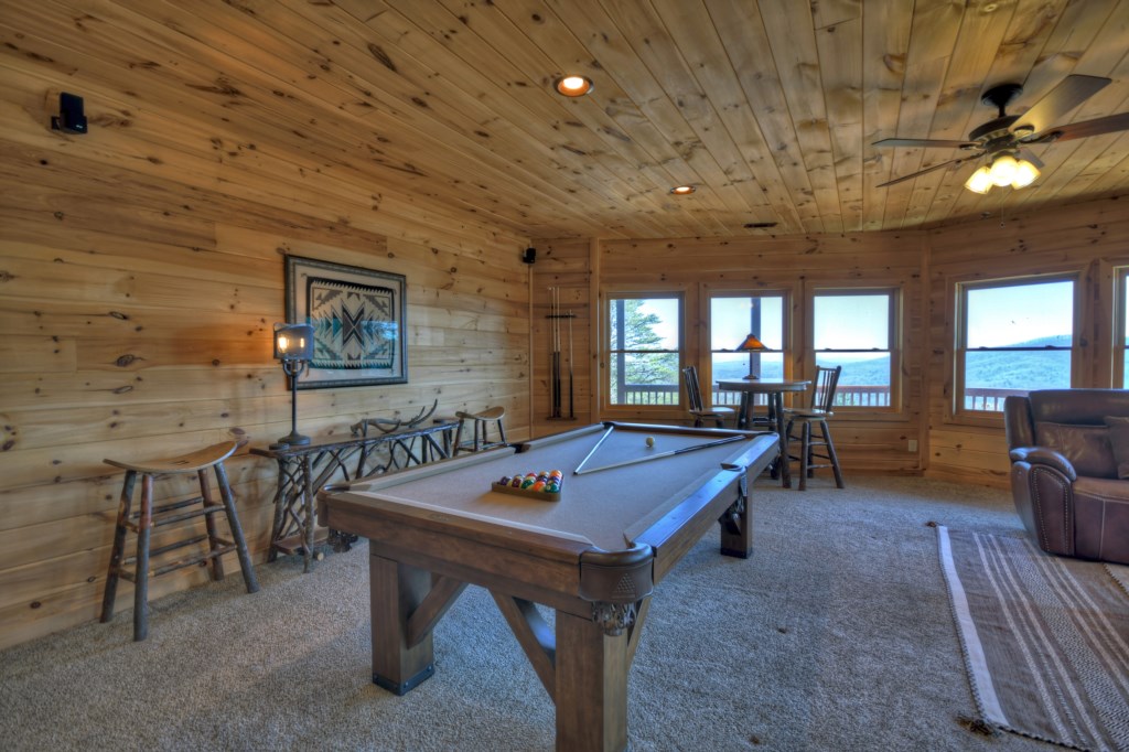 Living area in the terrace with pool table and tv