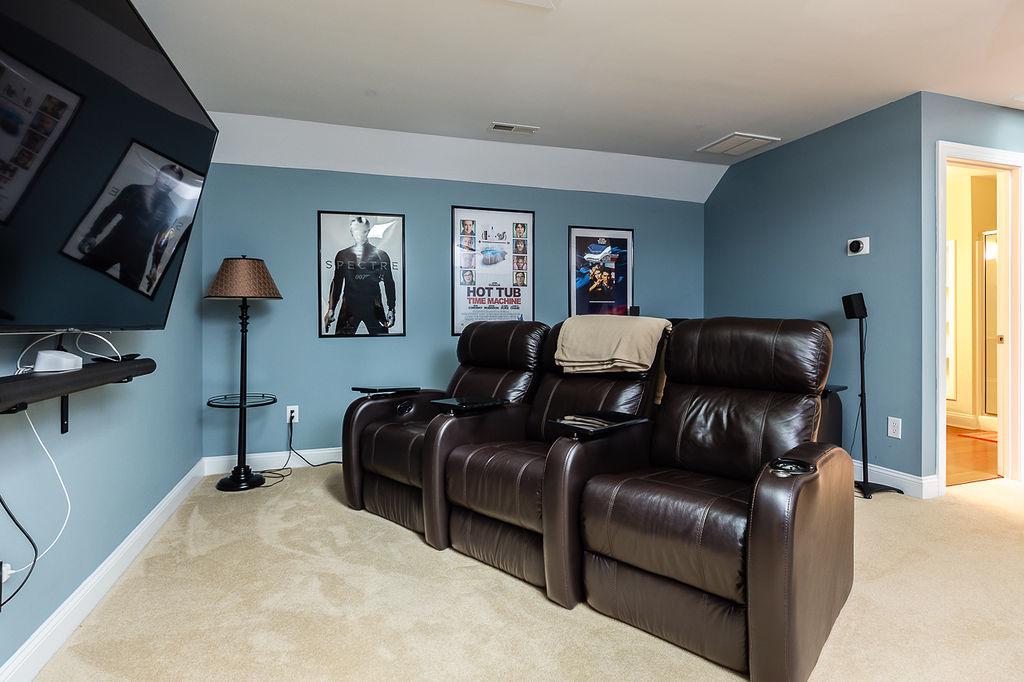 Basement with pool table, theater seating, and games. 