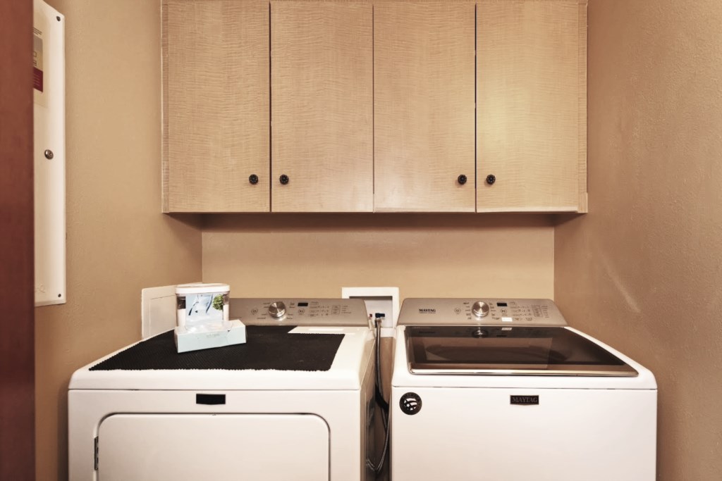 Convenient in-unit laundry area with modern washer and dryer.