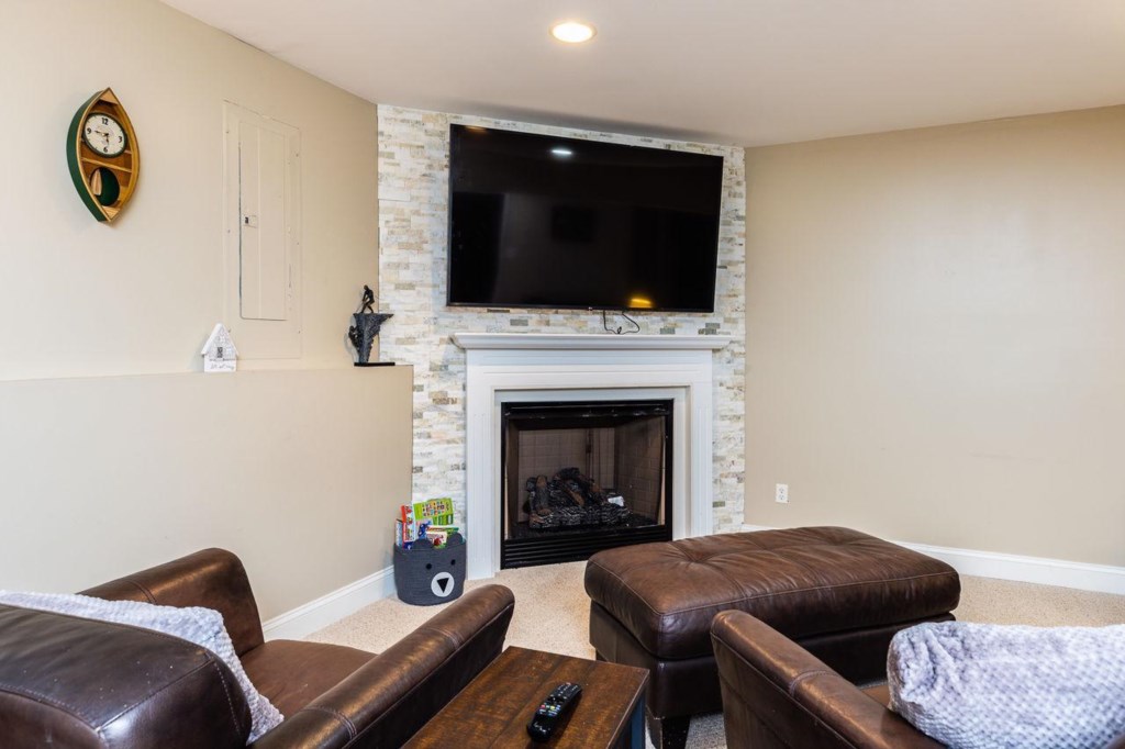 Cozy seating and large flat screen with gas fireplace. 