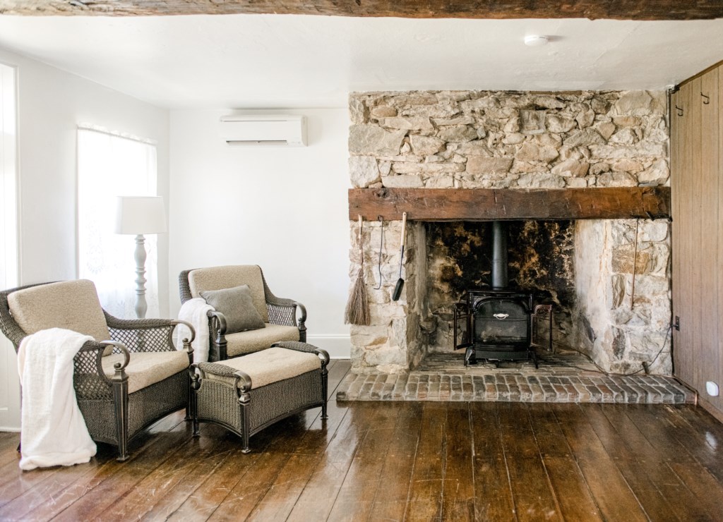 Super cozy indoor fire place. This original fire place has a beautiful and giant wood beam mantle. 