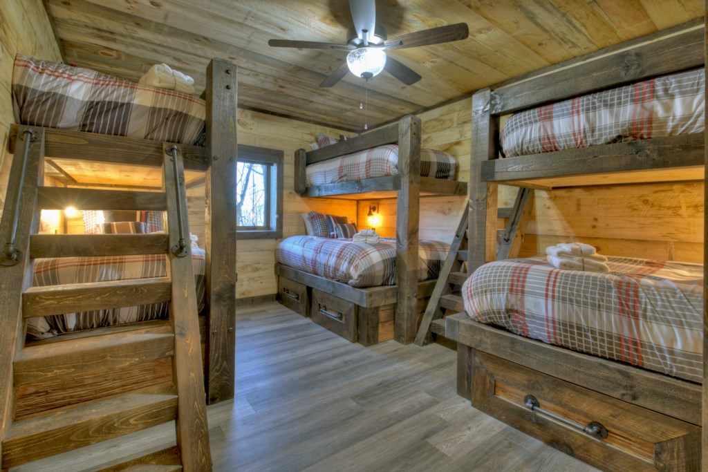 Bunk room in the terrace level with two twin over queen bunks and 1 twin over twin 