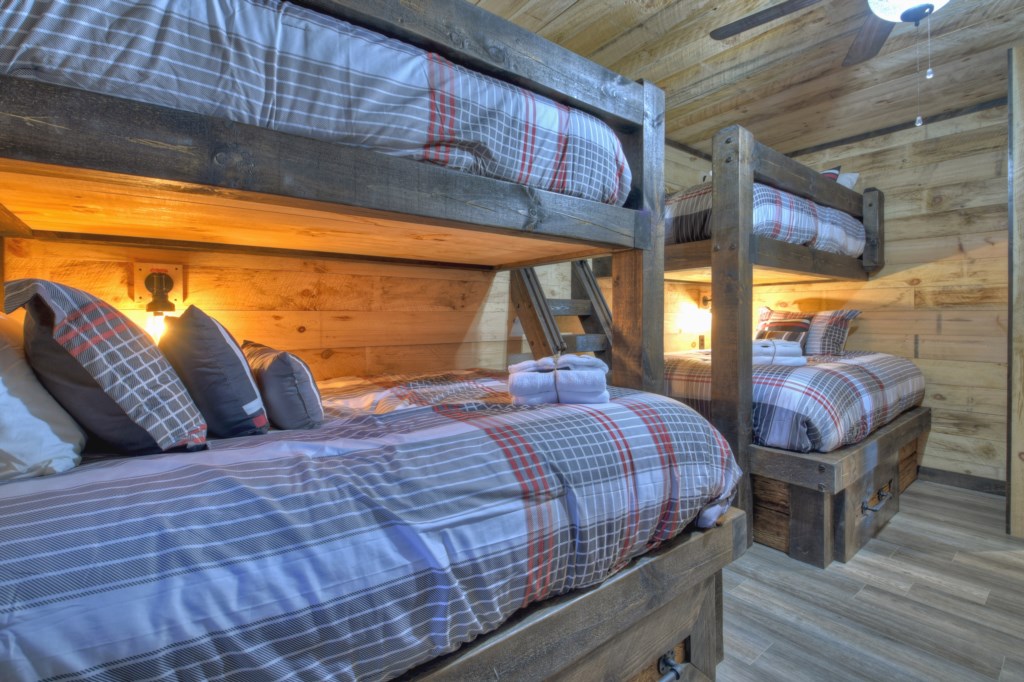 Bunk room in the terrace level with two twin over queen bunks and 1 twin over twin 